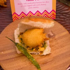 The quintessential Mumbai street food, Vada Pav, served with authentic green chutney and a fried chili. It's the kind of comfort food that brings a smile to everyone's face, no matter how grand the wedding.