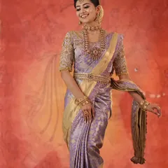 A smiling model showcasing the beautiful drape of the lavender saree and the intricate work on our custom designer blouse.
