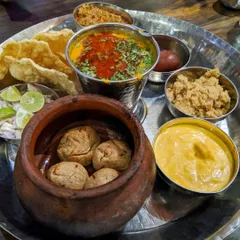My passion is cooking authentic regional dishes. This is a traditional Rajasthani thali featuring Dal Baati Churma, prepared with classic recipes to bring the true flavors of India to your celebration.