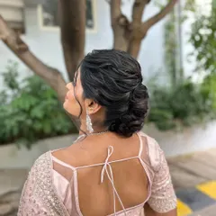 Another angle of the romantic textured bun, showing the intricate twists and folds of the hair.