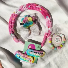 Another beautiful gift hamper, this one for Dhanya. It features a pink braided headband, a personalized bracelet, name clips, and a floral hair tie.