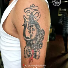 This powerful half-sleeve piece combines a portrait of Lord Shiva with his Trishul and Damaru. It's a complex design that shows my skill in creating detailed spiritual and mythological tattoos.