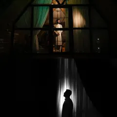 A powerful and creative composition of the groom, using reflection and silhouette to create a visually stunning image.