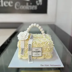 For the fashion lover, I designed this chic cake shaped like a classic Chanel handbag. The design features buttercream rosettes, an edible pearl handle, and the iconic logo ribbon, making it a perfect centerpiece for a luxury themed party.