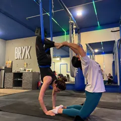 Partner work is a great way to build trust and strength. Here, two members create a beautiful, balanced shape, supporting each other through the pose.
