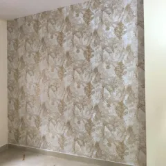 A textured damask wallpaper in beige and gold, giving a rich, layered look to the wall.