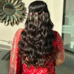 A closer look at this elegant engagement hairstyle. The soft waves are gathered into a half-updo, adorned with beautiful traditional jewelry that adds a touch of royalty.