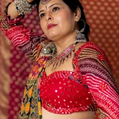 For festive events like Navratri, I love creating vibrant, detailed looks. I designed this entire dandiya outfit, from the mirror-work blouse to the multi-colored lehenga, complete with traditional silver accessories.