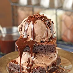 Our special brownie and ice cream combo is pure indulgence. It's a stack of warm brownies with chocolate ice cream and a rich chocolate drizzle.