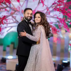 A grand reception look for a beautiful bride. The intricate silver lehenga is paired with soft, glamorous makeup and voluminous curls for a show-stopping effect.