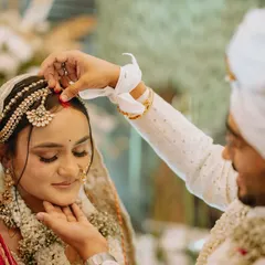 The sacred sindoor ceremony, a deeply emotional and significant moment for the couple, captured in a tight, intimate frame.