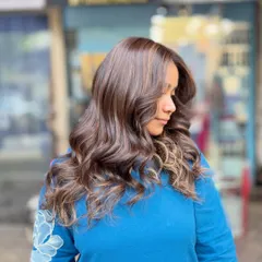 A soft blonde hair color achieved without bleach. This look adds gentle, warm highlights to a dark base for a subtle and natural-looking enhancement.