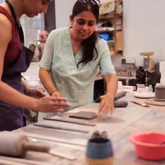 I’m Yashashri, and I’m here to guide you on your clay journey. In this photo, I'm helping a student with a hand-building technique, ensuring they feel comfortable and confident as they create.