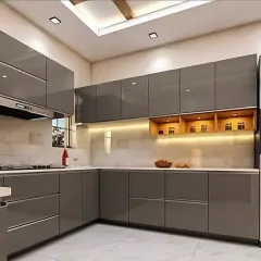 A contemporary L-shaped kitchen with handleless grey glossy cabinets and a built-in oven. The design includes open wooden shelves with accent lighting for a warm contrast.
