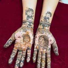 A unique baby shower mehendi featuring portraits of little Krishna and Radha on the palms, with drawings of the client's children on the forearms.