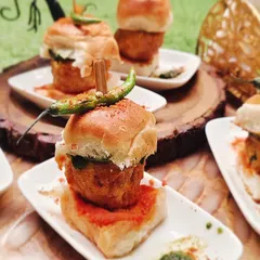 At first glance it looks like a vada pav, but we've added our own special twist. This appetizer features a crispy jackfruit fritter in a soft bun, delivering a unique and satisfying flavor profile that surprises and delights.