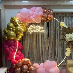 The vibrant pink, gold, and rose gold balloons create a glamorous and festive look, perfect for taking photos.
