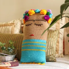 My Frida Kahlo inspired cushion, resting on a bed. I designed this piece to be a frank expression of creativity, adding a touch of art and personality to your most personal spaces.