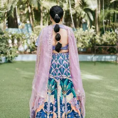 A look at the modern bubble ponytail, a chic and practical hairstyle that perfectly complements her vibrant Mehendi outfit.