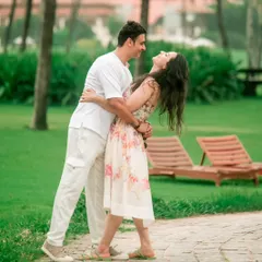 A joyful and spontaneous moment during a couple's shoot at a resort, where the groom-to-be dips his partner in a dance-like pose.