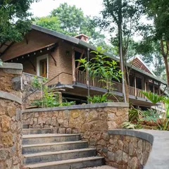 The PLENTI House in the Nilgiris, a social enterprise project I designed and built to house volunteers. The structure uses adobe blocks and local stone, and is terraced along the steep site to blend with the tea garden landscape.