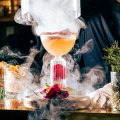 Smoky and charismatic, this cocktail is like a liquid love letter. Presented in a unique glass with a rose and smoke, it's the perfect way to celebrate a special moment.