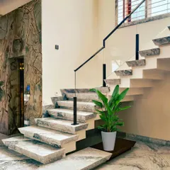 The staircase in our "House Reversed" project is a work of art, with cantilevered steps made of Palamino marble and a sleek, modern glass railing.