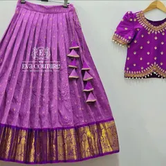 Another view of the elegant purple pattu lehenga. This angle highlights the pretty tassels on the skirt and the detailed embroidery work on the puff-sleeved blouse.