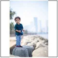 A portrait of a young boy against the hazy backdrop of the Mumbai skyline. Even in a busy location, I focus on capturing the quiet, thoughtful moments.