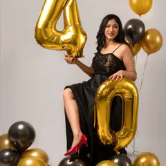 Another fabulous look from her 40th birthday celebration. The black and gold theme with balloons creates a chic and festive atmosphere, perfect for a milestone photoshoot.