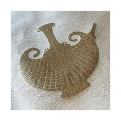 The 'Carafe' fabric is an opulent textile featuring abstract forms inspired by Indian Dokra metal casting. The gold embroidery on a cream base is perfect for creating decadent, art-inspired interiors.