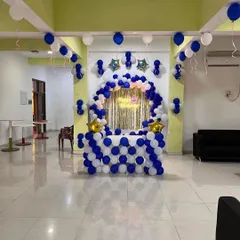A wide view of the blue and white cake table setup in a party hall.