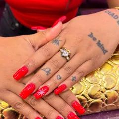 You can never go wrong with a classic, bold red. I use premium gel polish for a high-shine, chip-resistant finish that lasts for weeks. The simple, hand-painted starburst on the ring finger adds a personalized touch to this timeless manicure.