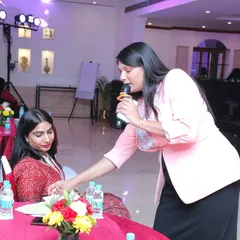 Getting up close with an attendee to hear her thoughts. I believe in making every person feel seen and valued, which is key to a successful and engaging event.
