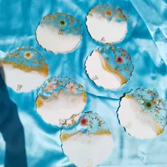 This is a full set of custom geode-style coasters, each personalized with a different initial. The combination of blue, white, gold, and preserved flowers creates a cohesive yet unique collection.