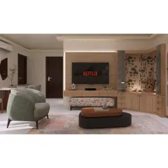 An overview of an open-plan living and dining area. The furniture arrangement, including the accent chair and patterned ottoman, helps define the lounge space while maintaining a sense of openness.