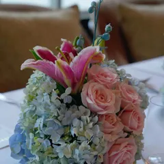 A close-up of a floral centerpiece from the Jimmy Choo event, highlighting the mix of pink lilies, roses, and blue hydrangeas. This level of detail ensures a luxurious feel throughout the venue.