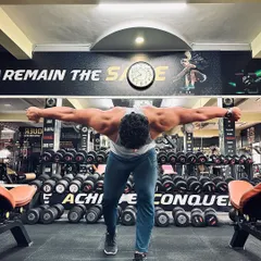 Live like a warrior, die like a legend. This rear delt fly pose highlights the separation and development of the upper back and shoulder muscles, a key part of a complete physique.