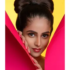 A great portfolio shot captures attitude. This close-up from a creative fashion shoot highlights the model's confident expression, complemented by the sharp lines of the prop and the bright yellow background. I focus on these details to ensure your personality shines through in every frame.