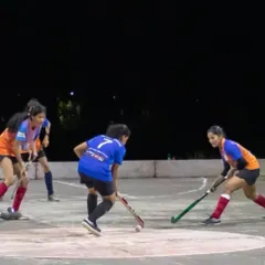 Players battling for possession during a night game. Our girls train hard and compete with the same intensity and passion as anyone else on the field.