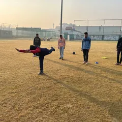 Balance and core strength are fundamental to a cricketer's performance. This image shows a player engaged in a dynamic balance exercise, a key part of our holistic fitness training regimen.