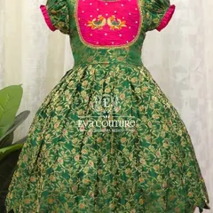 A similar Banarasi frock design with puff sleeves and a scalloped hem. The yoke features delicate peacock embroidery.
