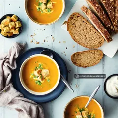 A comforting bowl of our creamy pumpkin soup, garnished with croutons and fresh herbs, and served with slices of multigrain bread. A wholesome start to any meal.