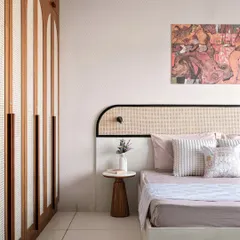 A closer look at the Japandi-inspired bedroom, highlighting the custom headboard with a black accent frame and the minimalist wooden side table. The abstract art adds a touch of modern personality.