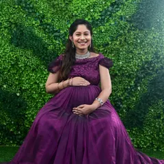 A happy, smiling portrait of a mom-to-be in our purple off-shoulder gown. My goal is to make you feel comfortable and capture your genuine joy.