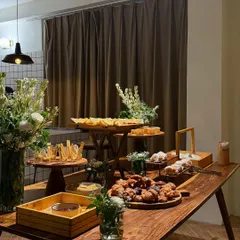 This beautiful grazing table was the star of a recent house party. It featured a mix of our handcrafted snacks, from mini vada pavs to crackers with hummus, all beautifully arranged on wooden platters.