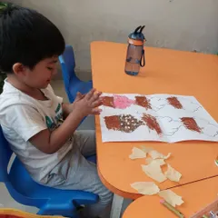 This little artist is using paper scraps to add a fun, textured topping to his cupcake drawing. Mixed media art is all about experimentation.