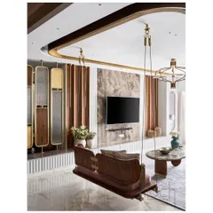 A view of the living room from the side, showing the reversible swing and its relationship to the TV wall. The design uses natural daylight to create a bright and airy feel, highlighting the mix of materials.