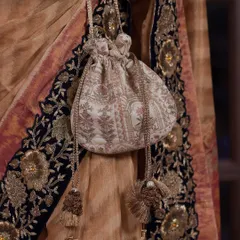 The iconic white and gold Amyra potli is the ultimate plus-one for any festive moment. Its classic design and intricate detailing offer timeless charm, making it a versatile accessory for everything from sundowner weddings to regal sangeets.