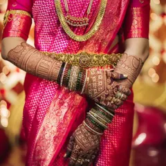 The beauty of dark shades. A deep, mature henna stain looks stunning paired with a vibrant pink Kanjivaram saree and traditional gold jewelry.